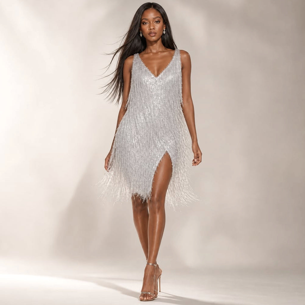 Model trägt das Sovi Pailletten-Mini-Kleid mit Stufenfransen, stehend vor neutralem Hintergrund